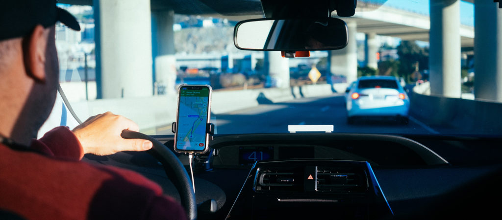 man using phone GPS while driving